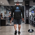 Oversized vintage black long sleeve t-shirt pump cover featuring a premium high-contrast back print of the cracked, stone-textured Apocalypse Gym Wear signature skull logo design.