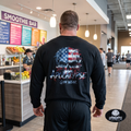 Apocalypse Gym Wear, Premium black relaxed-fit heavyweight cotton long sleeve gym shirt pump cover featuring a massive back print of a gritty watercolor American flag skull graphic with aggressive dripping typography.