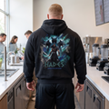 Apocalypse Gym Wear Hades Lord of the Underworld heavyweight black hoodie worn by a bodybuilder in a gym. Back view showing large Hades graphic guarded by Cerberus with icy teal accents and 3D textured typography.