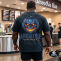 Apocalypse Gym Wear blue pumpkin skull black t-shirt worn by a bodybuilder in a gym. Back view showing a massive glowing orange and icy blue jack-o'-lantern back print.