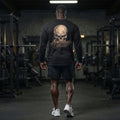 Model Back View: Apocalypse Gym Wear Bone Skull black long sleeve t-shirt back view worn in gym setting showcasing the full back bone skull graphic.