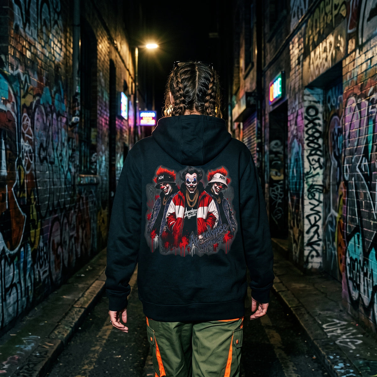 Apocalypse Gym Wear Clown Mob black pullover hoodie back view displayed in an alleyway showing the full back clown trio print.